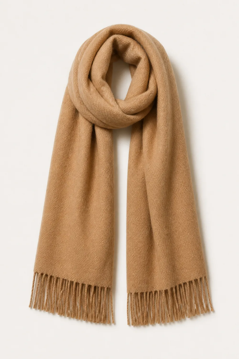 Long camel wool scarf laid in a soft fold with fringed ends and a visible weave